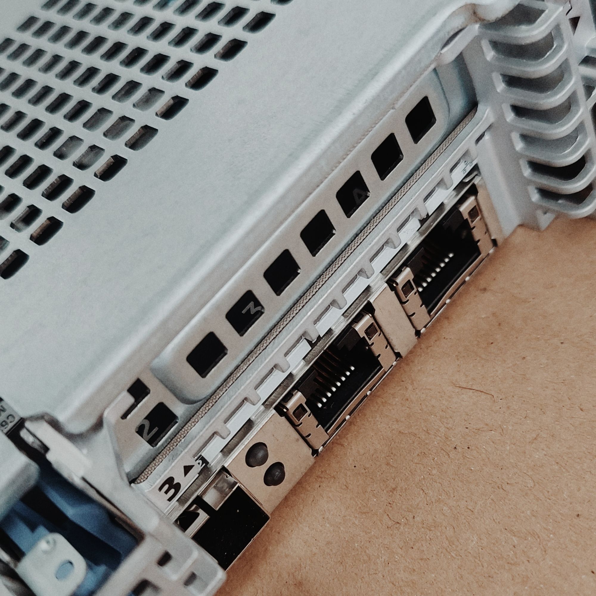 Back of a 1HE server machine. A network interface connector with a number 3 stickered on it. Two ports, disconnected.