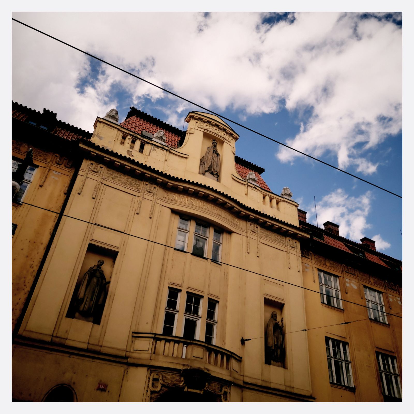 A yellow facade decorated with religious figures. 