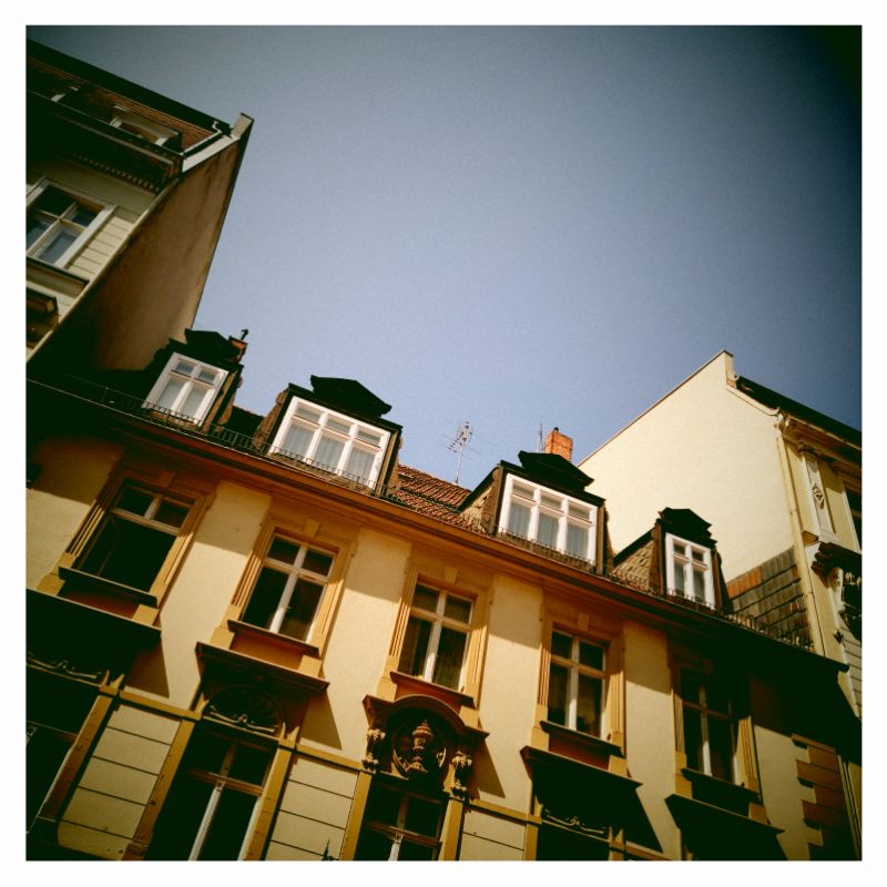 Roof and facade of an old house, seen from below.