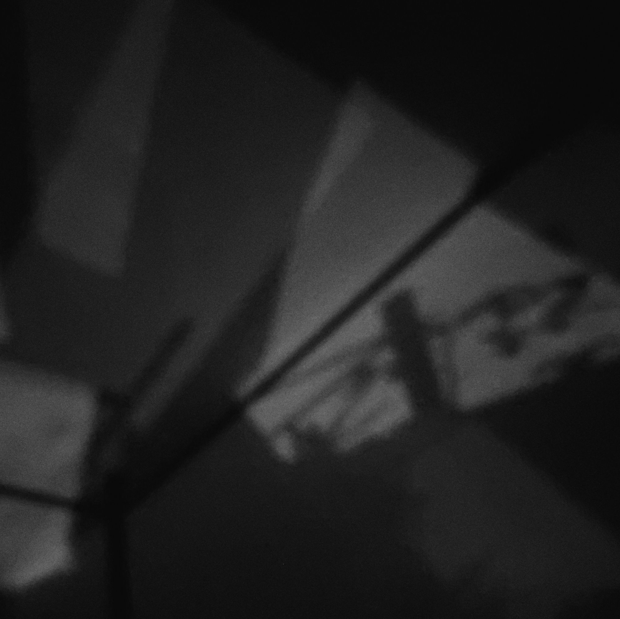 Random shadows on wall and ceiling of a darkened room.