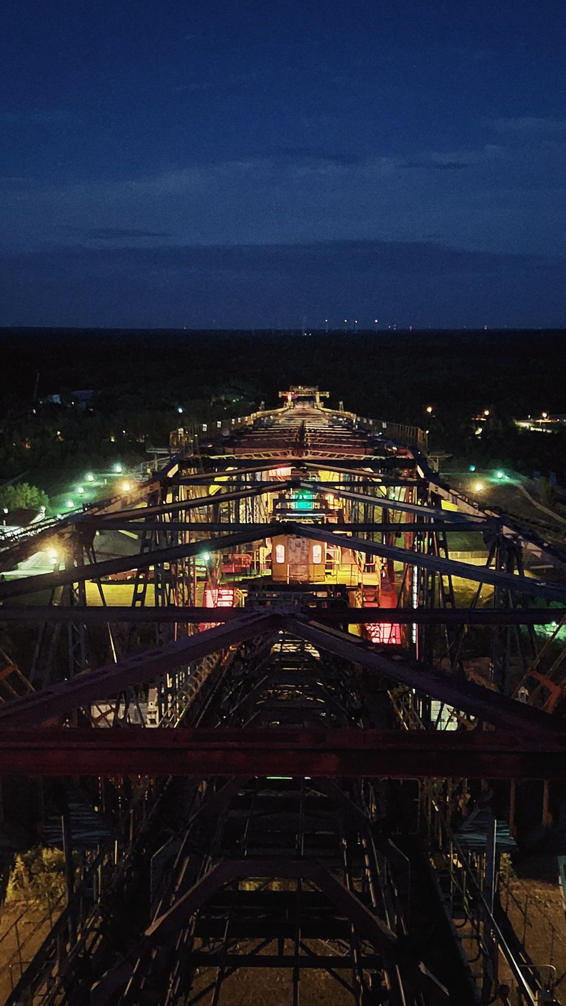 Looking down into an illuminated mining device from above. Night.