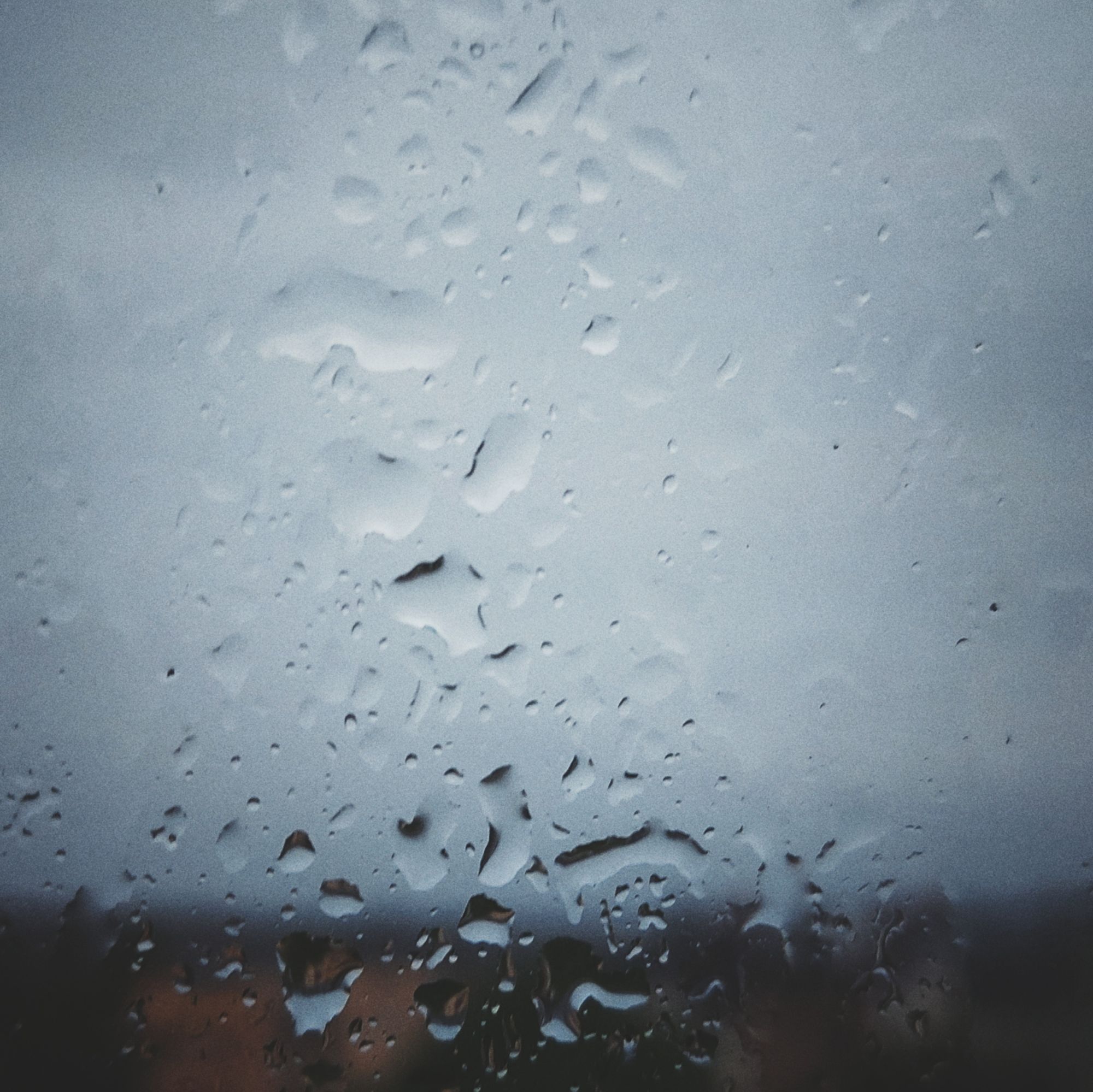 Dark clouds, raindrops on a windowpane. 