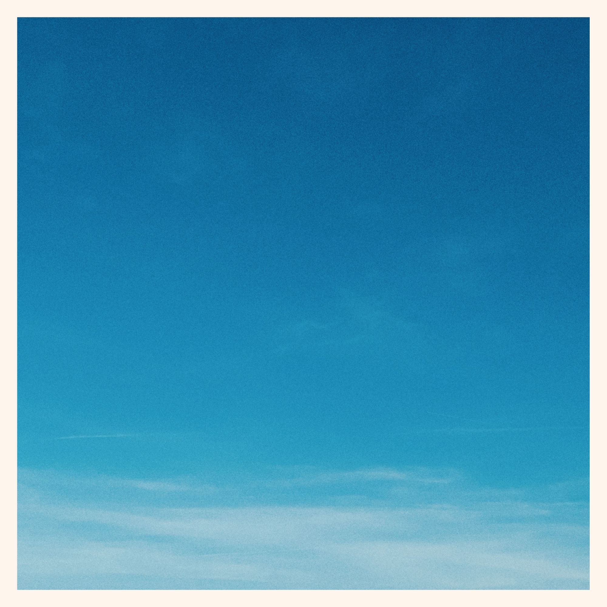 Bright blue sky with lines of white on the lower border.