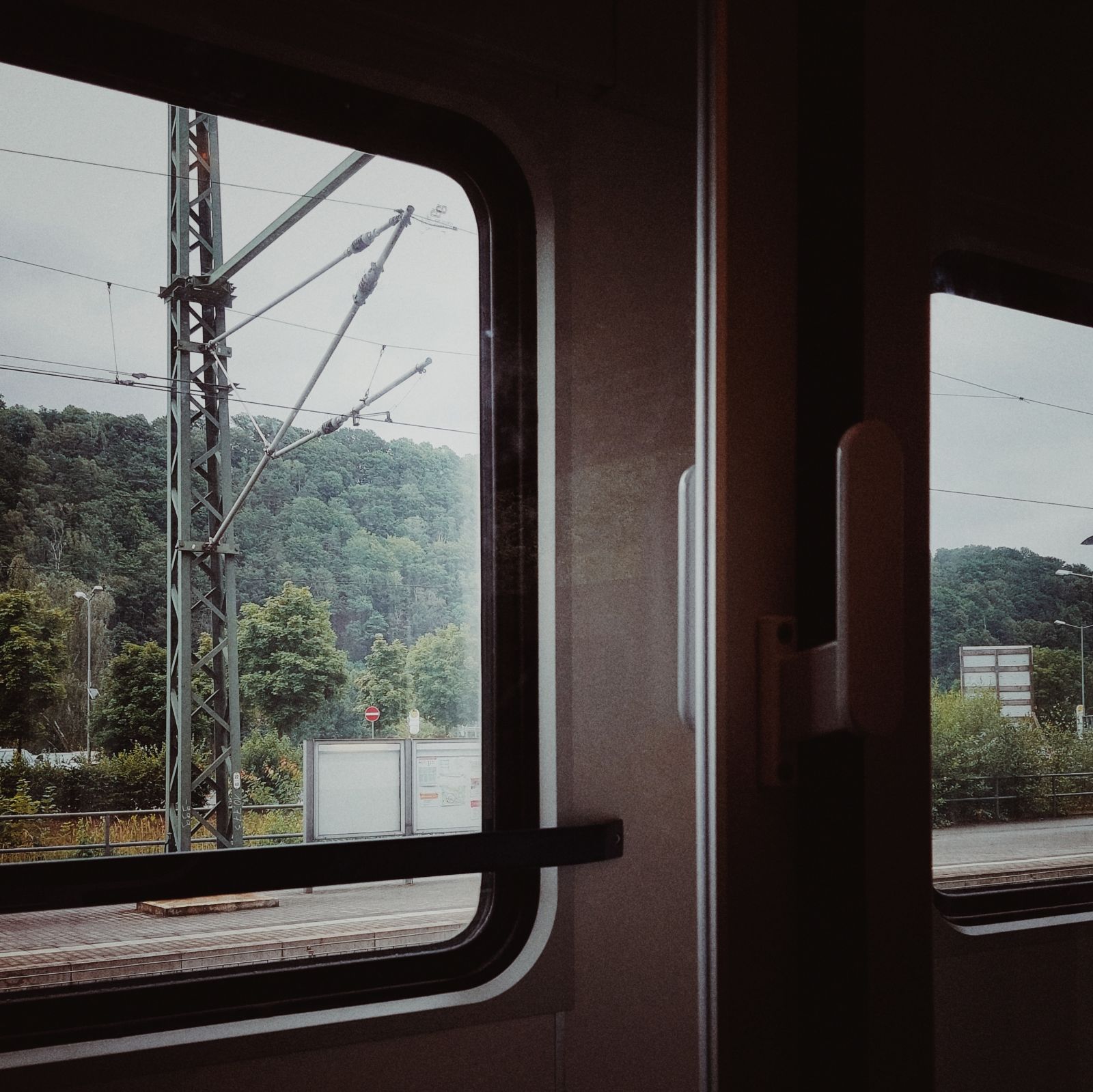 Infrastructure behind a train window.