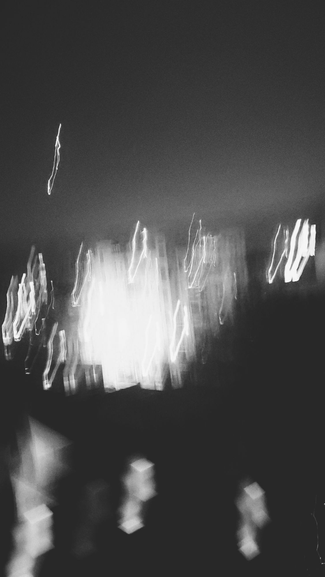 Monochrome blurred shot of city windows in a backyard. 