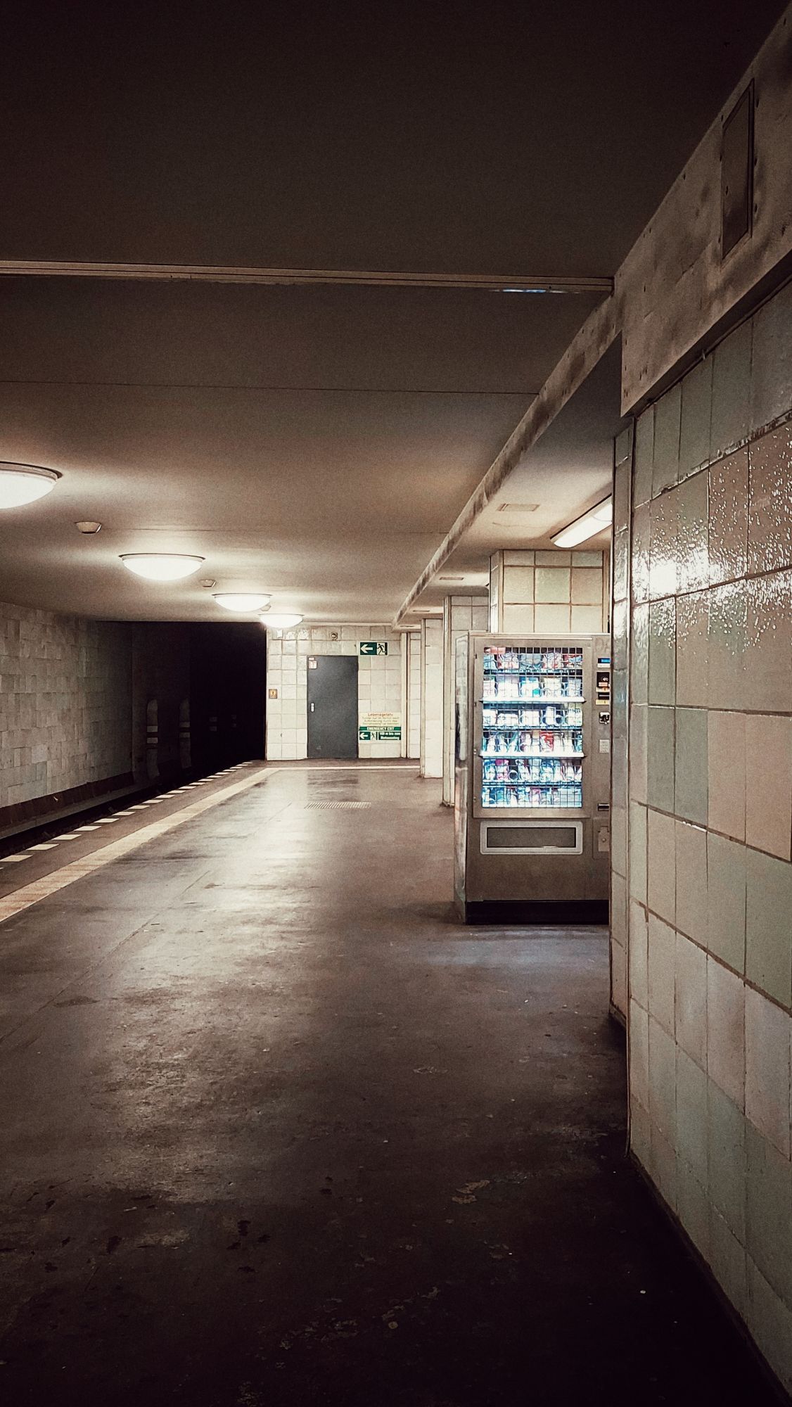 A snack vending machine in an empty subway station