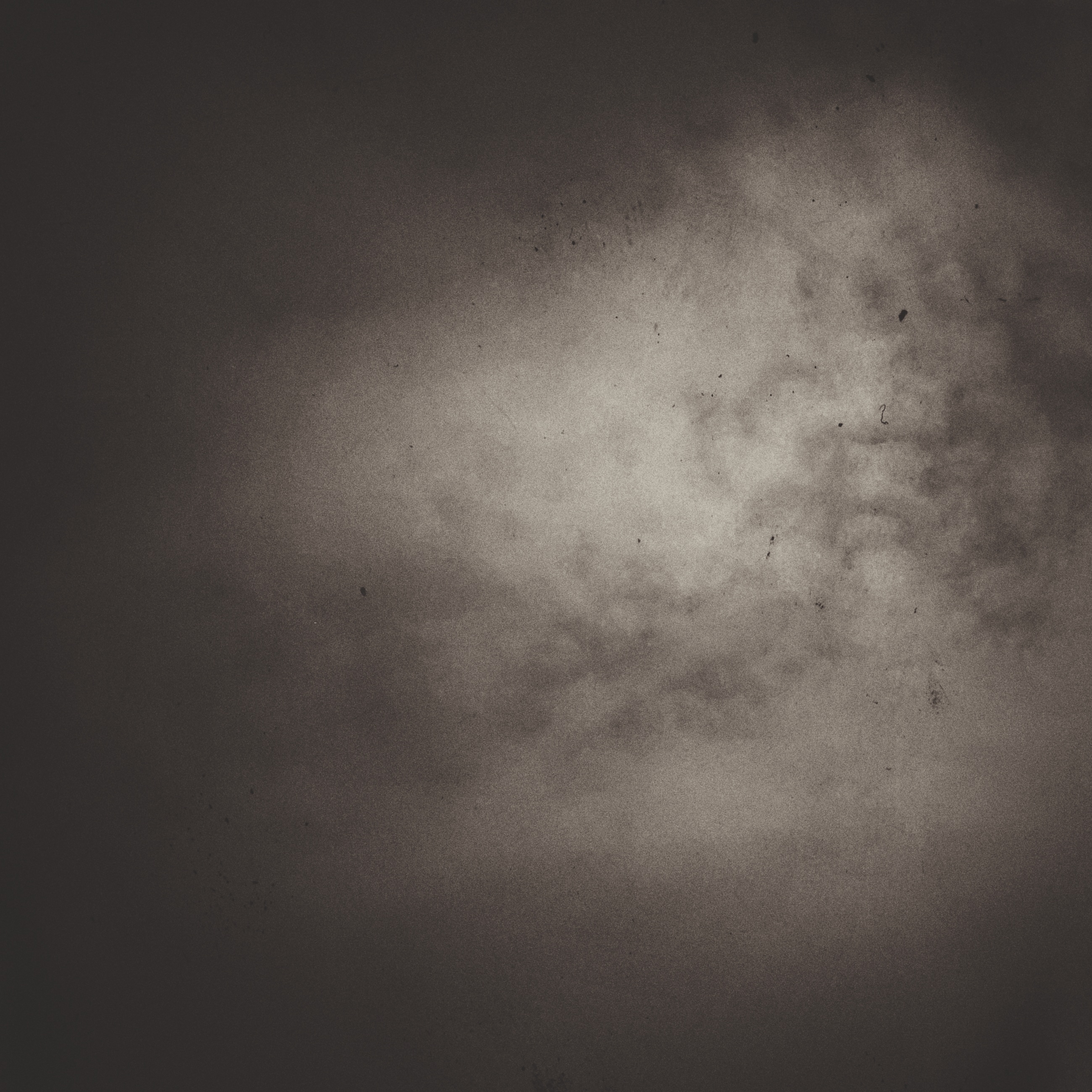Monochrome night sky, overexposed grainy clouds.