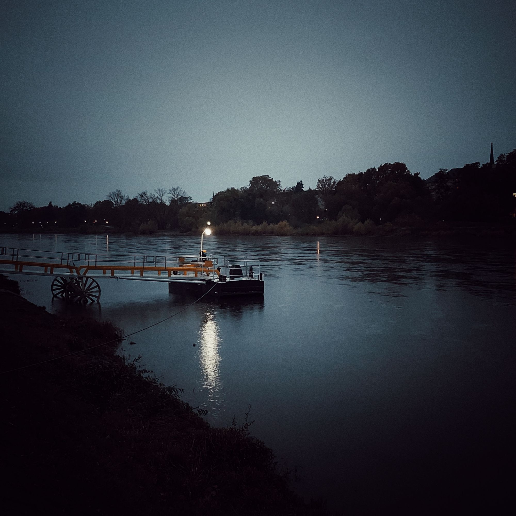 A light on a ferry stop, Elbe river. Early night.