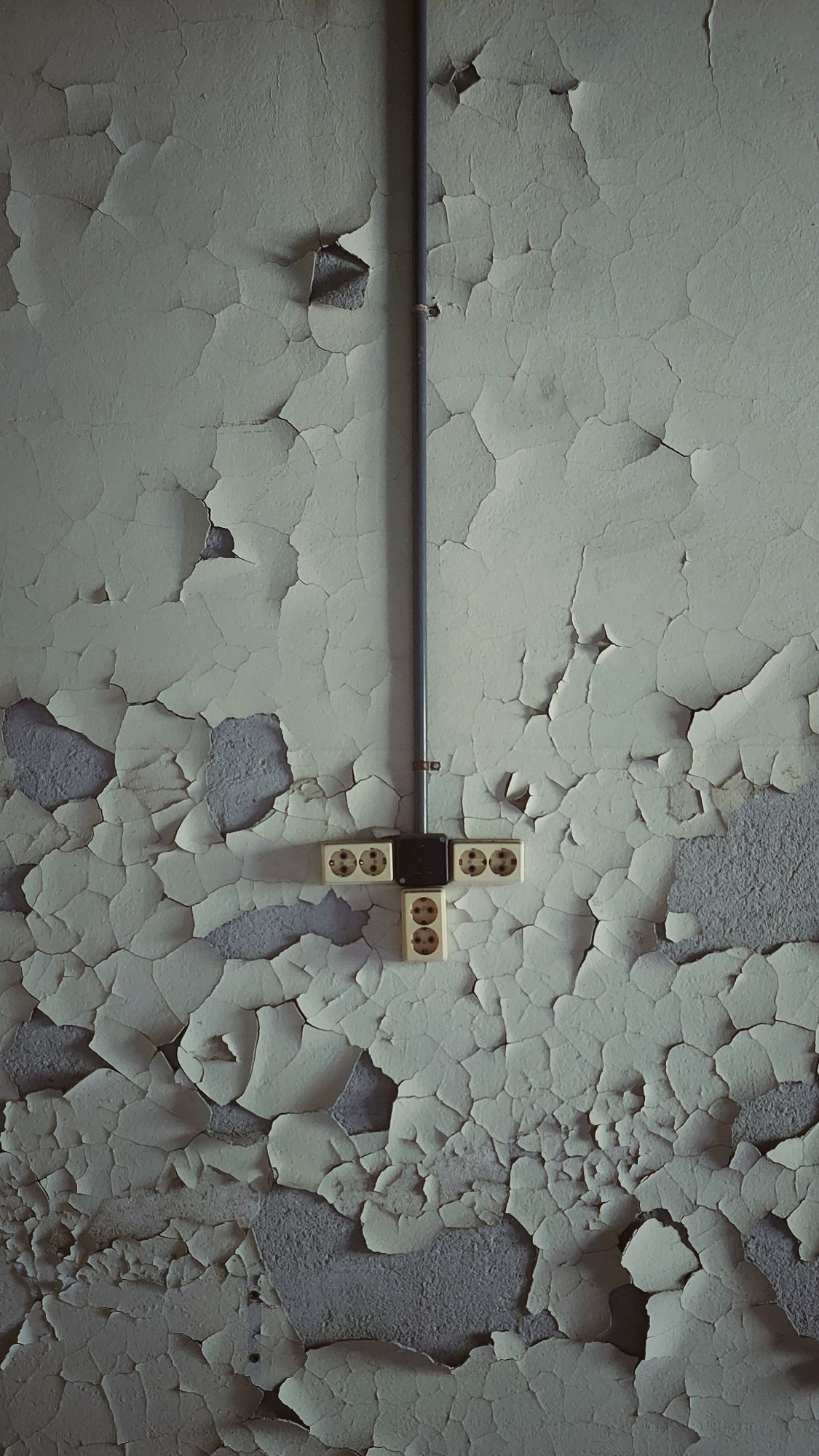 Electric sockets on an old wall.