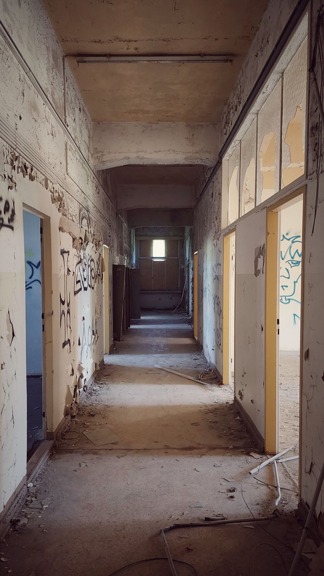 A hallway without doors, dirty and left abandoned  